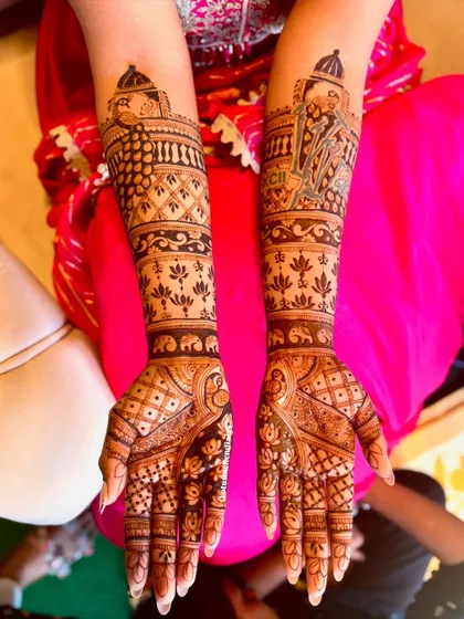 The complete bridal mehendi for Chandini, showcasing a unique design that includes a depiction of the Eiffel Tower, blending personal memories with traditional art.