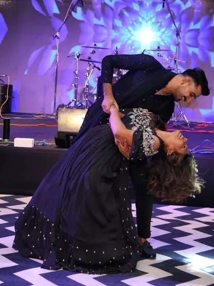 This is the kind of magical moment we love to create. A perfect dip on stage captures the romance and joy of a couple's first dance. We focus on creating beautiful poses like this that make your wedding photos and memories unforgettable.