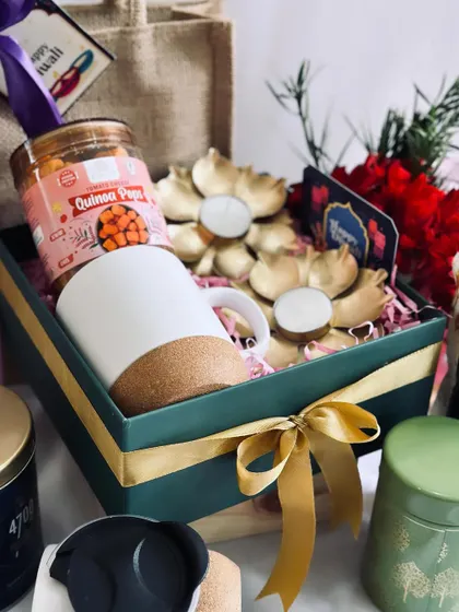 A closer look at the contents of the green and gold gift box, showing the beautiful lotus diya holders.