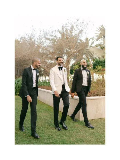 The groom, Moin, sharing a laugh with his groomsmen in Dubai. Capturing these moments of friendship and celebration is an important part of the wedding story.