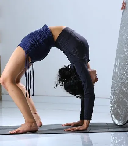 Holding Urdhva Dhanurasana (Wheel Pose) during a photoshoot. This pose builds strength and opens the entire front body.