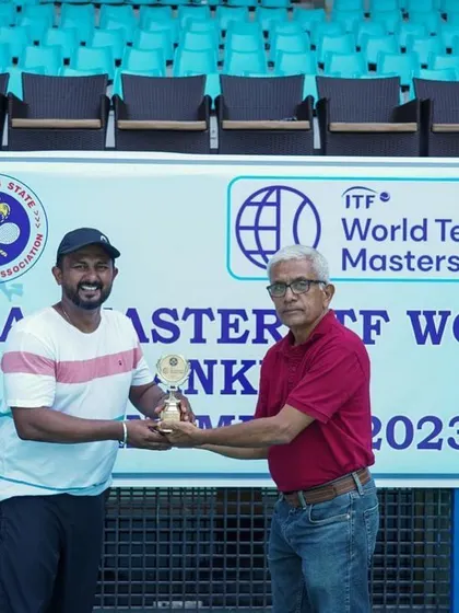 Receiving my ITF World Tennis Masters Tour trophy. This personal achievement fuels my passion for coaching and my belief in a process-driven approach to success for all my students.