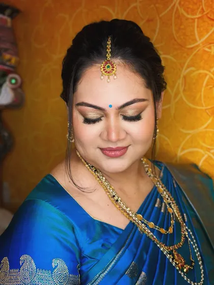 A serene portrait. The soft, blended makeup and traditional jewellery create a look of timeless beauty and grace.