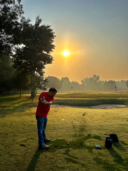 A beautiful sunrise over the range as a golfer takes a swing. Starting your day here is a truly special experience.