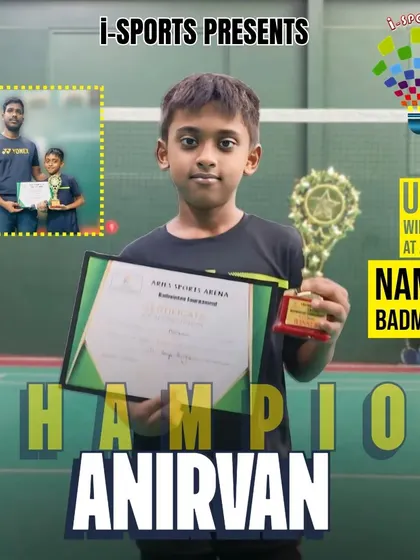 Champion Anirvan celebrates his U11 winner's trophy at the Namma Badminton tournament held at Aries Sports Arena.