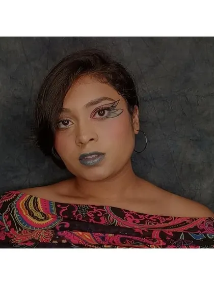 This look features a custom butterfly wing eyeliner. It's an example of graphic liner art where I turn a familiar shape into a unique makeup element, paired with a cool-toned blue lip.