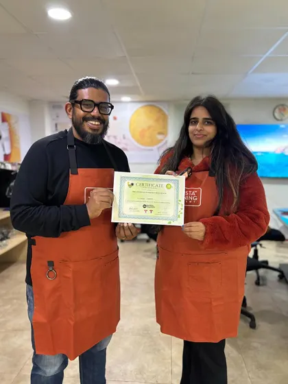 A proud student receives her certificate after successfully completing the Matcha Masterclass.