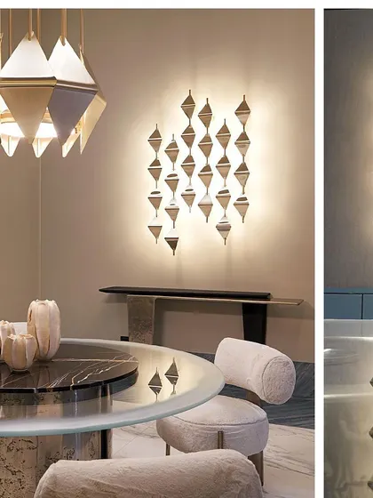 This dining area features a complete set of our custom geometric lighting. The design of the hanging pendant light is mirrored in the illuminated wall sconce, creating a cohesive and sophisticated lighting scheme.