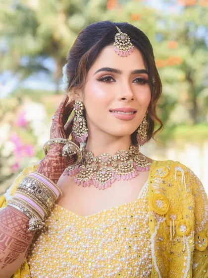 A final, glowing portrait from the Haldi day. The makeup is fresh, radiant, and perfectly suited for a daytime celebration.