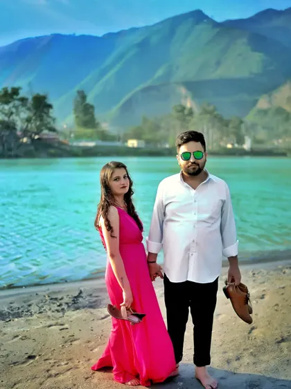 A relaxed pre-wedding photo of the couple walking barefoot on the sand by the river. It's these casual, unposed moments that often show the most genuine connection.