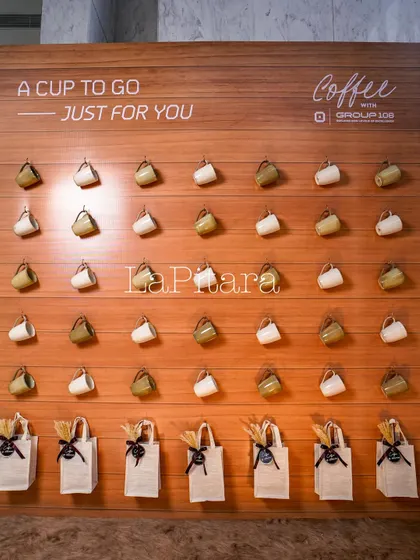This interactive giveaway wall was a highlight of the event. We designed it with rows of coffee mugs and branded jute bags, creating an engaging and memorable way for guests to receive their parting gifts.