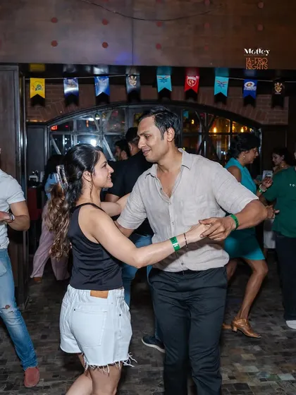 A classic dance hold, with both partners focused and connected. This image captures the essence of partnership in Latin dance.