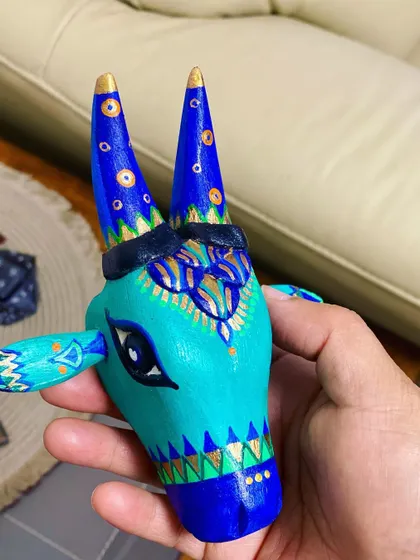 A duplicate image of the teal and blue Nandi, showing its intricate gold highlights.