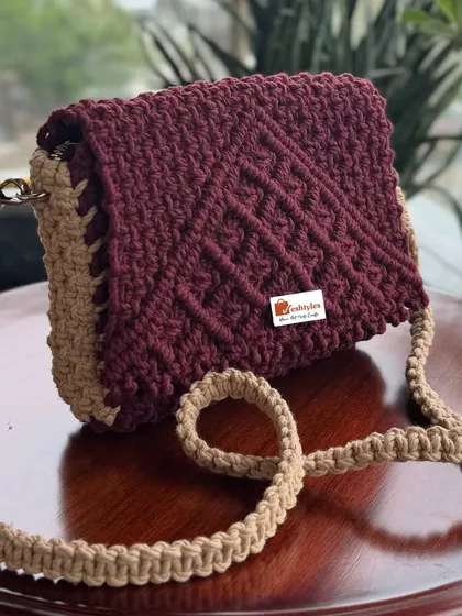 This two-tone sling bag in maroon and beige has such a sophisticated look.