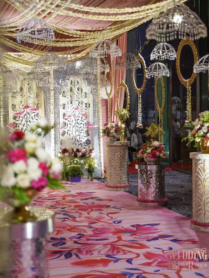 This aisle combines traditional and modern elements, with a floral carpet, crystal umbrellas, and ornate mirrors lining the path. It’s a perfect example of our eclectic and personalized design approach.