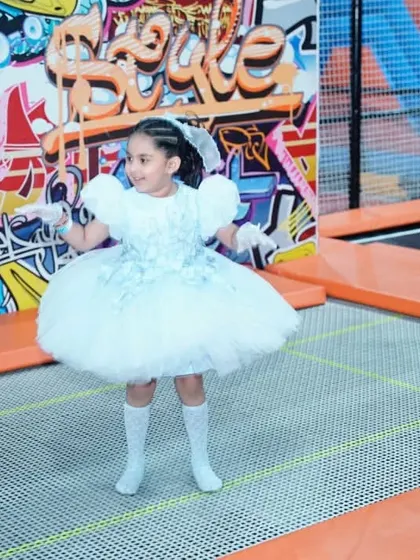 Even birthday princesses can't resist the fun of our trampolines! A girl in a beautiful gown enjoys a gentle bounce.