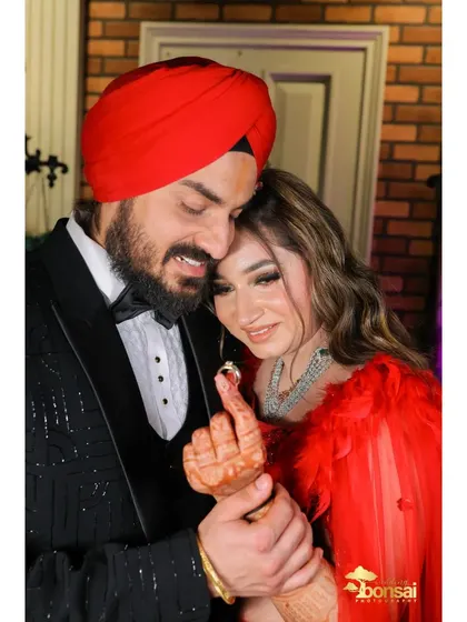 An intimate shot of the couple showing off their engagement rings.