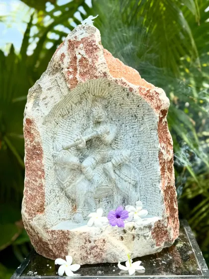 This niche carving shows Krishna playing his flute, a beautiful piece of art that brings a story of divinity to your garden.