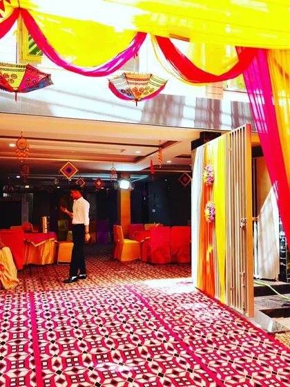 A view from the entrance of a decorated hall, showing the seamless transition from the outdoor tent to the indoor event space.