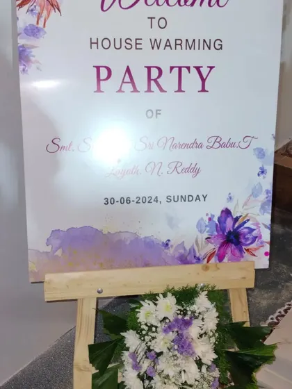 A personalized welcome sign is a lovely touch for any event. This modern easel sign with a watercolor floral design formally welcomes guests to the housewarming party, providing key event details in an elegant way.