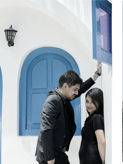 A collage featuring a stylish shot against a Santorini-style building.