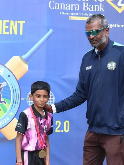 A coach congratulates a young player on his achievement during the award ceremony.