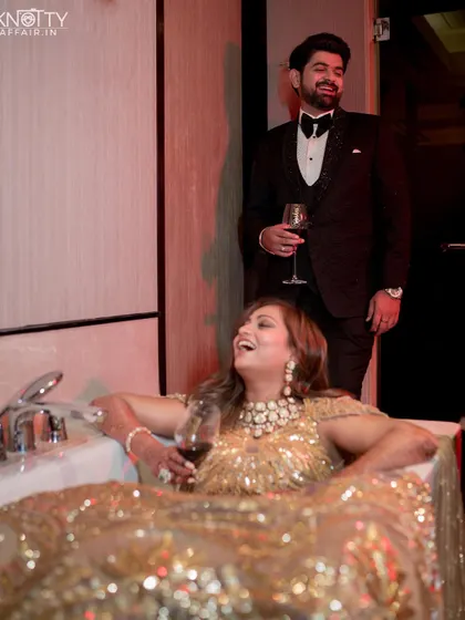 The couple sharing a laugh during their quirky bathtub photoshoot after the reception. We create a comfortable space for couples to be themselves.