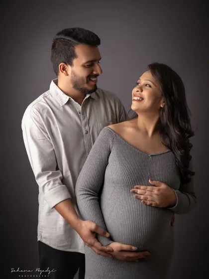 The loving gaze between a couple says it all. This candid moment is full of warmth and happiness, a perfect memory of their pregnancy journey.