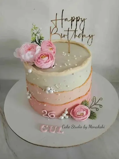 Pretty in pink for a 26th birthday. This no-fondant cake features a lovely ombre effect from white to pink, adorned with delicate flowers and sugar pearls.