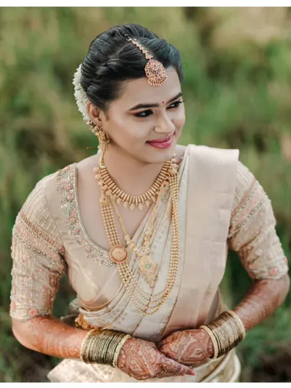 A stunning close-up bridal portrait, highlighting the bride's flawless makeup and beautiful traditional jewelry.