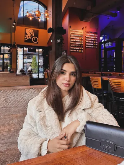 A portrait shot inside a cozy, wood-paneled restaurant in Blue Mountain.