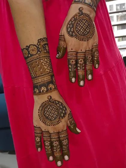 A matching set of hand and foot mehendi, featuring mandala designs for a coordinated look.
