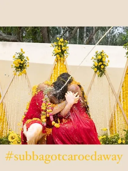 A framed shot of the couple sharing a hug during their Haldi, capturing a moment of colorful celebration.