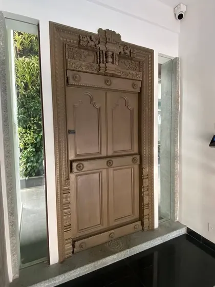 Another angle of the antique door at our office entrance, juxtaposed with modern security systems, representing our blend of old and new.