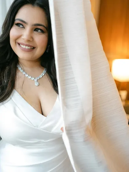 A close-up by the window, with the warm light creating a beautiful glow. The makeup is soft, romantic, and utterly timeless.