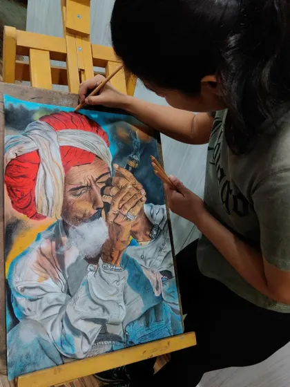 Me working on my first major soft pastel portrait. You can see the concentration it takes to blend the colors and bring the subject to life.