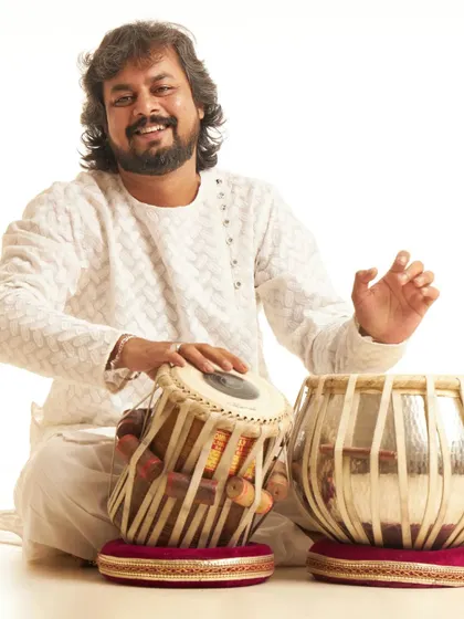 A smiling portrait with my tabla. I am grateful for the opportunity to share my music, and this photo captures the joy that playing brings me.