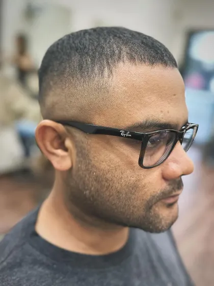 A side profile of a classic skin fade crew cut. This is a no-fuss, sharp look where the hair is faded right down to the skin for an ultra-clean finish.