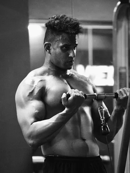 A black and white shot of me during a bicep curl. The focus and intensity are the same in every workout.