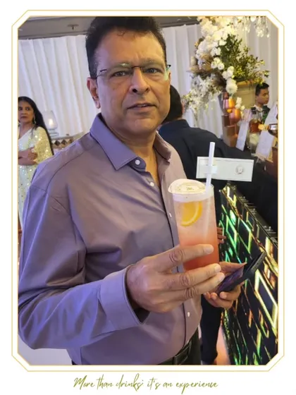 A gentleman enjoying a refreshing cocktail. We cater to guests of all ages, ensuring everyone feels welcome and well-served at our bar.
