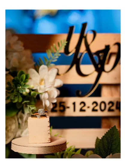 A close-up detail shot of an engagement ring resting on a custom-made platter with the couple's initials and date.