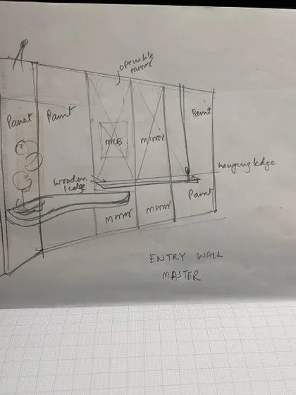 A detailed sketch for the entry wall of a master bedroom. This drawing outlines the placement of mirrors, paint finishes, and a custom wooden console, serving as a crucial communication tool for our team and artisans.