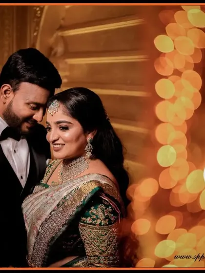 A beautifully composed reception portrait using warm bokeh lights. This technique adds a magical and dreamy quality to the couple's photos.