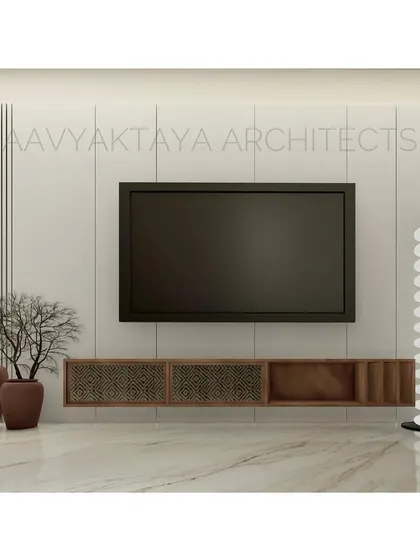 A living room concept centered around a minimalist media wall. The floating console incorporates woven rattan details, and the wall is accented with vertical fluting. Potted cacti and a sculptural floor lamp add organic and artistic touches.