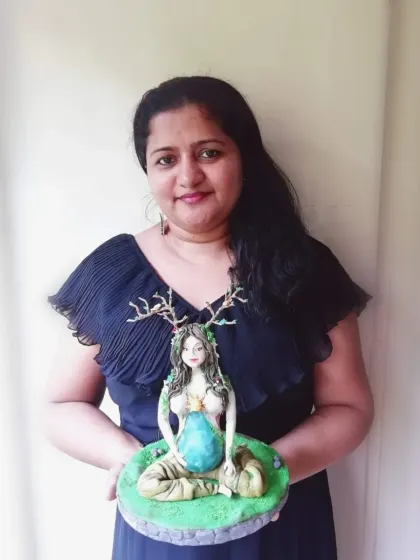 Here I am holding my finished Mother Earth sugar sculpture. It was a challenging and rewarding project, and I love teaching others the skills to create their own works of art.