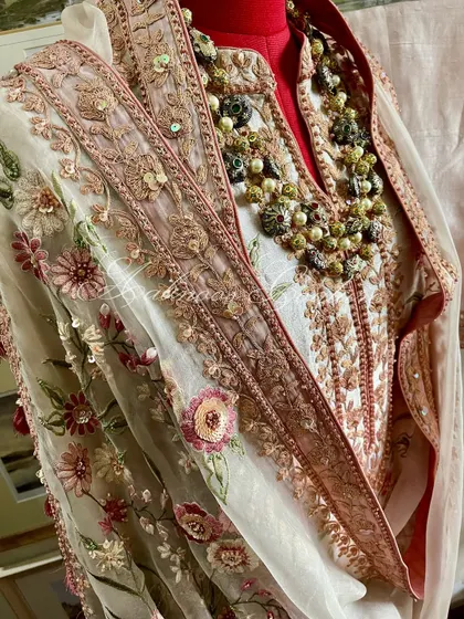 A mannequin shot of the suit, styled with a necklace to show its festive readiness.