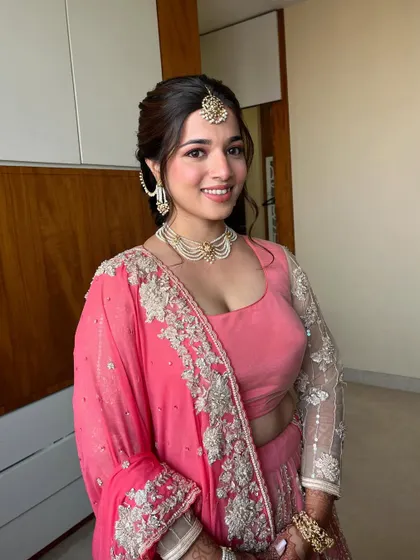 For this bride's third event, she glowed in a dreamy baby pink lehenga. We kept the look natural and fresh with soft pink tones on the eyes, cheeks, and lips.