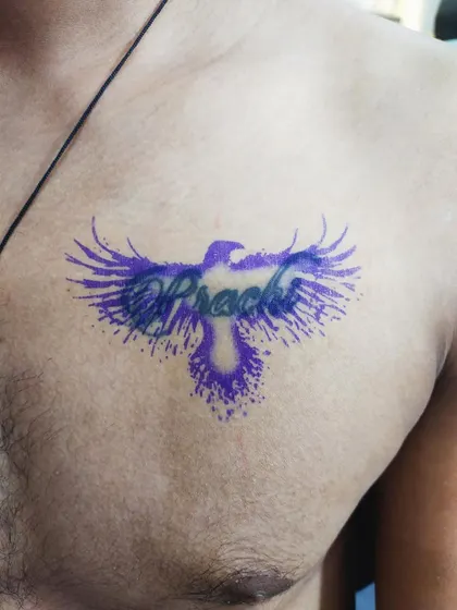 Before: The stencil is applied for a cover-up on the client's chest, showing how we plan the new design to hide the old name tattoo underneath.