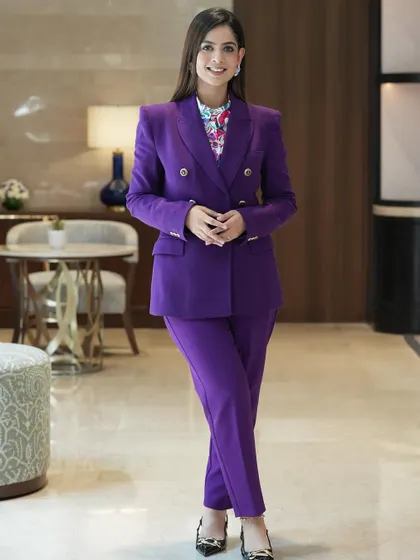 A vibrant purple blazer paired with a floral top. I love adding a pop of color to my corporate wardrobe to stand out while maintaining a professional look.