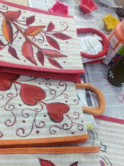 A close up of some of the finished jute bags from a fabric painting workshop. Each design is unique and beautiful.